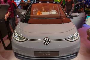 Couple sits in the new electric car by Volkswagen: VW ID.3 with LED matrix headlights and holographic head-up display