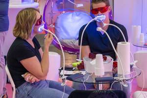 Couple tests painless teeth whitening system by Only Smile at Fibo in Cologne, Germany