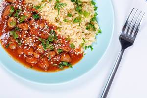Couscous with beans in tomato sauce and herbs