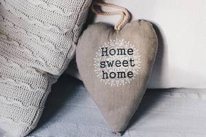 Cozy couch with a "Home, sweet home"heart shaped  pillow