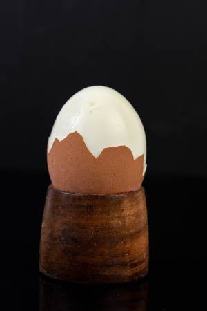 Cracked Boiled Egg above black reflective background (Flip 2019)