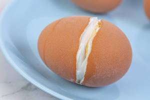 Cracked Hard Boiled Egg on the blue plate
