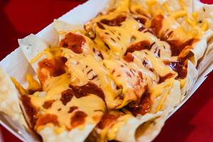 Crispy nachos covered in cheese and barbeque sauce