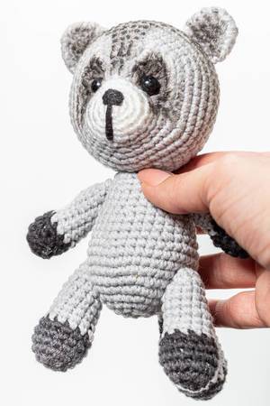 Crochet toy raccoon in hand closeup (Flip 2019)
