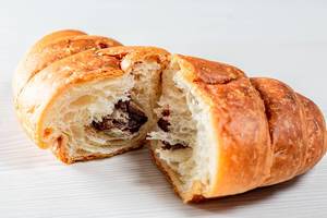 Croissant with chocolate filling on white background