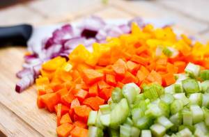 Cube Vegetables on a Cutting Board (celery, onion, carrot, pepper )