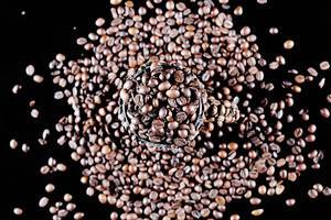 Cup full of coffee beans, black background (Flip 2019)