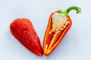Cut red pepper halves on white background (Flip 2019)
