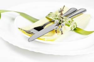 Cutlery-on-white-plates-with-a-napkin-and-ribbon.jpg