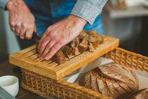 Cutting  Dark Bread Slices  On Wooden Board