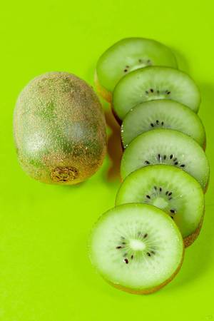 Delicious and healthy kiwi fruit on green background