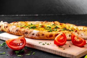 Delicious baked Adygei khachapuri with cheese dough, egg and herbs