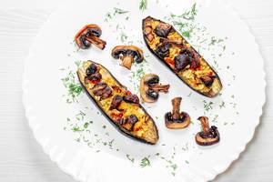 Delicious baked eggplant with champignons on plate. Top view (Flip 2019)