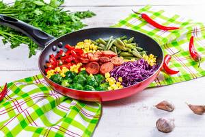 Delicious Breakfast with vegetables and sausages on the table with parsley and garlic (Flip 2019)