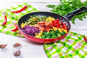 Delicious Breakfast with vegetables and sausages on the table with parsley and garlic