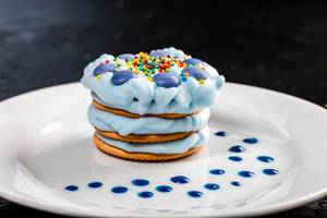 Delicious dessert with blue cream on a white plate (Flip 2019)