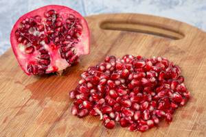 Delicious Fresh Pomegranate seeds on the wooden board (Flip 2019)