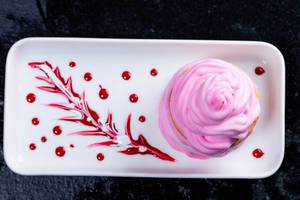 Delicious pink dessert with cream and sweet berry sauce (Flip 2019)