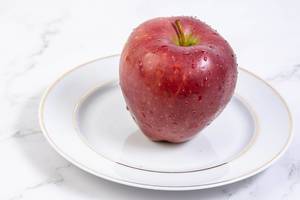 Delicious red Apple on the plate