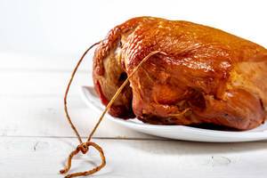 Delicious smoked chicken breast on a white background