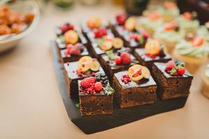 Delicious Sweet Brownie Squares With Various Berries On Top