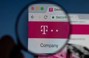 Deutsche Telekom logo on a computer screen with a magnifying glass