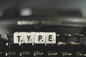 Dice reading TYPE  on a keyboard