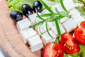 Diced feta cheese with tomatoes and olives