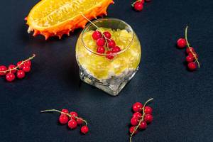 Diet food-cottage cheese with kiwano and red currant on a dark background (Flip 2020)