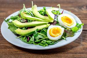 Diet salad with herbs, boiled eggs and avocado (Flip 2019)