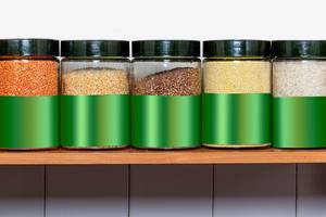Different groats in glass jars on the shelf