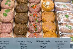 Different turkey burger patties at food bar of Whole Foods Market