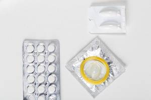 Different types of contraceptives on a white background