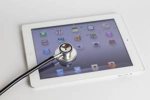Digital tablet And stethoscope on white table