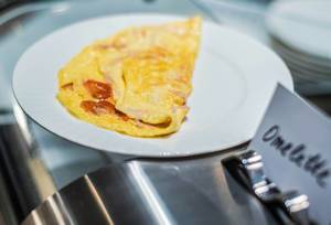 Dish Of Omlette With Ham And Tomatoes