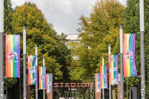 Diversity campaign day for tolerance and LGBTQ rights by German sports teams: way lined with rainbow flags in front of German football stadium