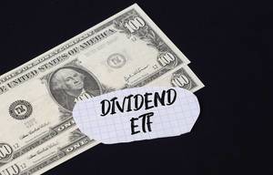 Dividend ETF text and dollar banknotes
