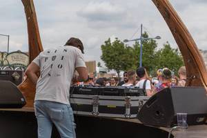 DJ plays music with a Pioneer audiomixer in a futuristic DJ stage at the entrance of Tomorrowland festival