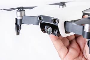 DJI Mavic Air drone in the hand above white background (Flip 2019)