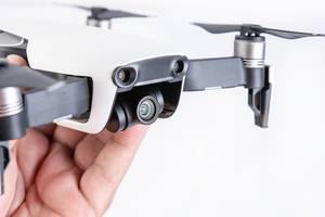 DJI Mavic Air drone in the hand above white background