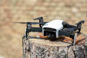 DJI Mavic Air drone parked on the tree stump