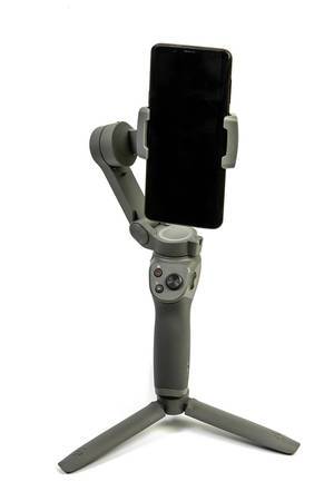 DJI Osmo Mobile 3 phone gimbal with mobile phone attached above white background (Flip 2019)