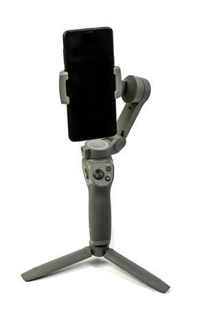 DJI Osmo Mobile 3 phone gimbal with mobile phone attached above white background