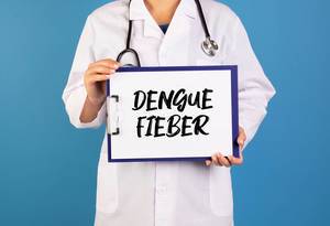 Doctor holding clipboard with Dengue Fieber text