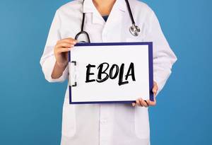 Doctor holding clipboard with Ebola text