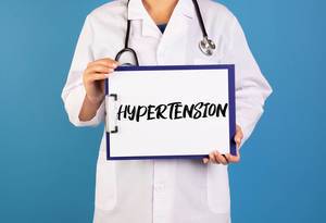 Doctor holding clipboard with Hypertension text