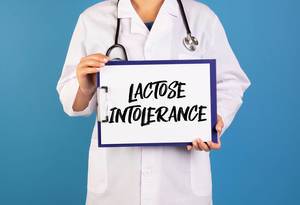 Doctor holding clipboard with Lactose Intolerance text