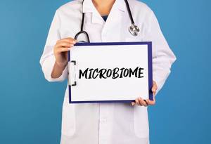 Doctor holding clipboard with Microbiome text