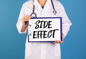 Doctor holding clipboard with Side effect text