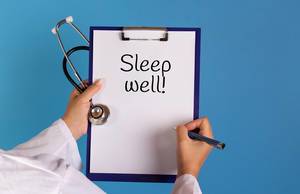Doctor holding clipboard with Sleep well text